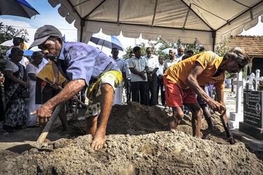 Grave diggers bury a victim of the suicide bomb attacks in Negombo, Sri Lanka, April 23, 2019. Jack Moore / The National.