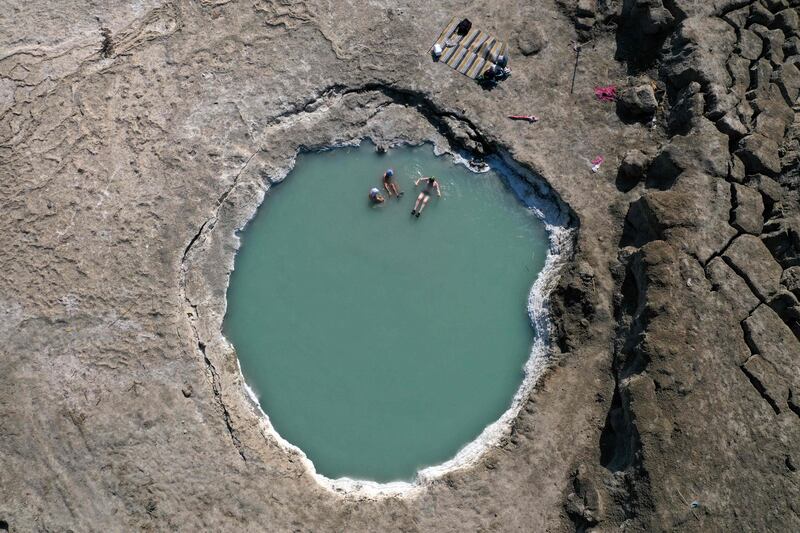 Men take a dip in a sinkhole on the shore near the Mitzpe Shalem settlement in the occupied West Bank.