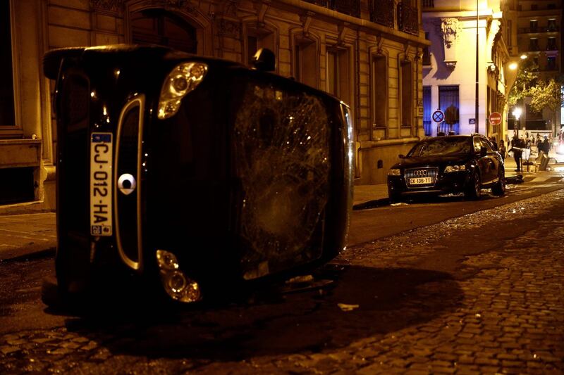 A turned-over car near the Champs-Elysees in Paris. AFP