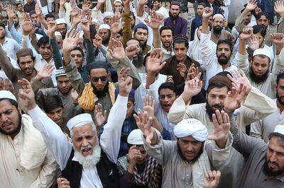 Muslim protesters shout slogans during a demonstration in Peshawar on October 30, 2020, following French President Emmanuel Macron's comments over the Prophet Mohammed caricatures. - Tens of thousands of protesters across South Asia vented their fury at France on October 30, with a crowd in Bangladesh burning an effigy of President Emmanuel Macron as anger flared over his tough stance on Islamic extremism. (Photo by Abdul MAJEED / AFP)