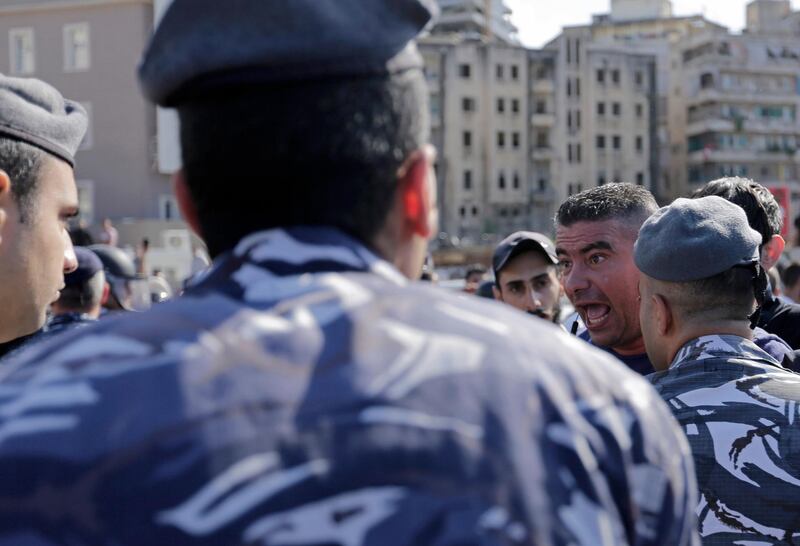 A Hezbollah supporter, right, scuffles with Lebanese riot policemen during clashes between an anti-government protesters and Pro-government protesters. AP