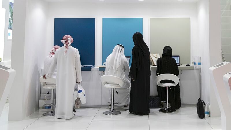 ABU DHABI, UNITED ARAB EMIRATES, Feb. 2, 2015:  
Emirati nationals peruse the exhibition near the Mubadala stand, checking out and applying for possible jobs at Tawdheef, a job fair open to UAE citizens only, on Monday, Feb. 2, 2015, at the Abu Dhabi National Exhibition Center.  (Silvia Razgova / The National)  /  Usage: Feb. 2, 2015 /  Section: NA  /  Reporter: Amna

 *** Local Caption ***  SR-150202-Tawdheef49.jpg