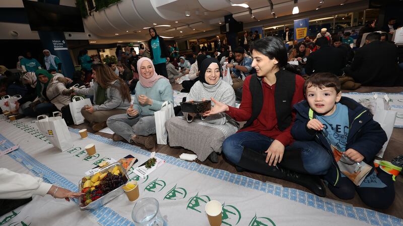 Food is passed along the line as more than 400 members of the Muslim community enjoy iftar at the American Express Community Stadium. Photo: Brighton and Hove Albion