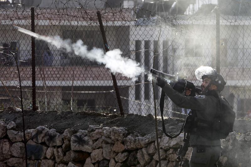 An Israeli border policeman fires tear gas during clashes with Palestinian demonstrators following a protest in the West Bank city of Bethlehem, on January 29, 2020. AFP