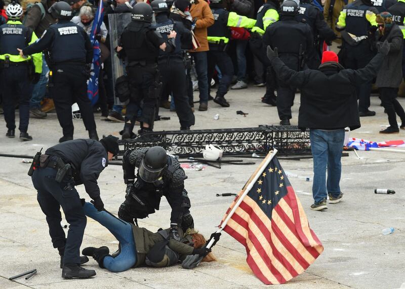 Police detain a person as supporters of US President Donald Trump protest outside the US Capitol. AFP