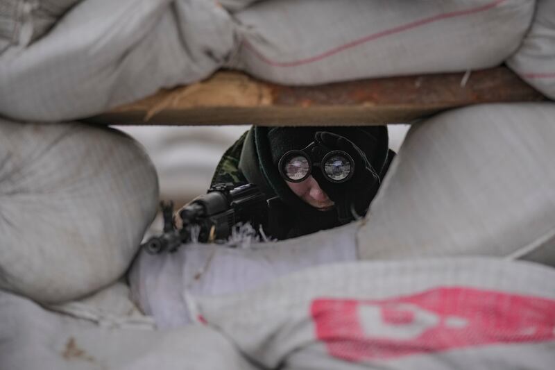 A Ukrainian soldier at a checkpoint in Kyiv. AP