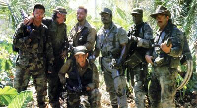 From left to right, actors Shane Black, Sonny Landham, Arnold Schwarzenegger, Carl Weathers, Jesse Ventura and Bill Duke, with Richard Chaves kneeling in front, in the film 'Predator'. Courtesy 20th Century Fox