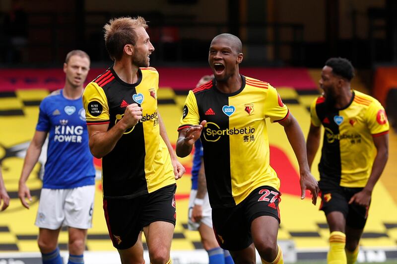 Watford's Craig Dawson, left, celebrates after scoring his side's opening goal during the English Premier League soccer match between Watford and Leicester City at the Vicarage Road Stadium in Watford, England, Saturday, June 20, 2020. (AP Photo/Alastair Grant, POOL)