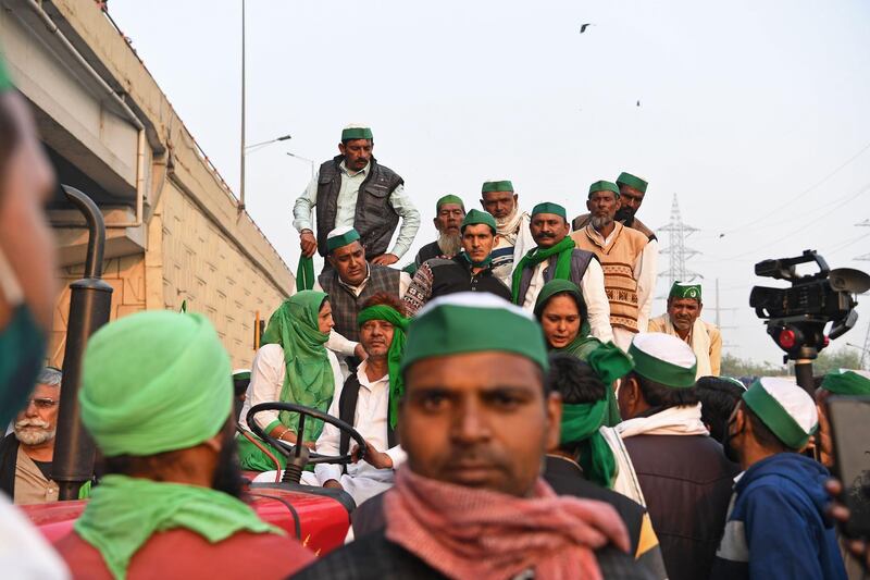 Farmers are seen in a tractor trolley near a police road block stopping them from marching to New Delhi to protest against the central government's recent agricultural reforms AFP