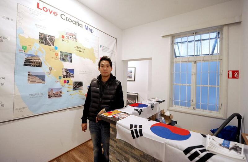 Kim Seoung-hoon poses in front of a giant map marked with Croatia’s main destinations, at the entrance of his Korean-only Love Croatia hostel in the capital Zagreb. AFP 