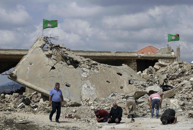 Visitors perform noon prayers amid the ruins of the former Israeli-run prison of Khiam (Khiyam) on the Lebanese-Israeli border.   AFP