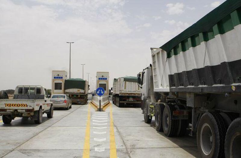 Lorries queue yesterday at the Al Dhaid tollgate plaza in Sharjah. It was the first day that drivers were charged Dh100 to use the road.