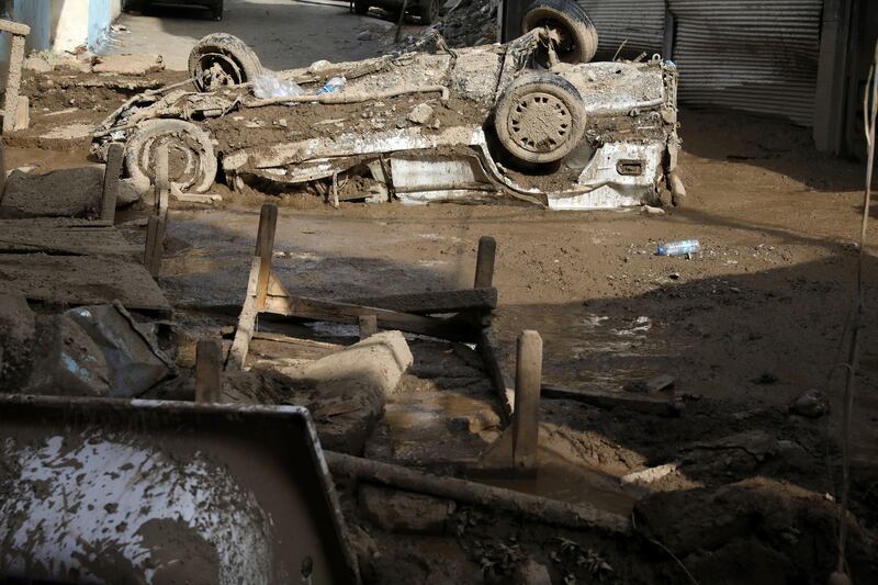 Buildings and vehicles were damaged by the floodwaters and subsequent mudslides. AP Photo