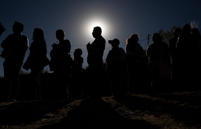 People stand in line for their chance to view the solar eclipse through a telescope in an astronomical complex at the University Mayor de San Andres in La Paz, Bolivia. AP Photo