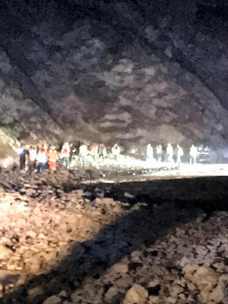 The 20 passengers are led to safety on foot in the Hatta valley on Tuesday night. Courtesy: Dubai Police