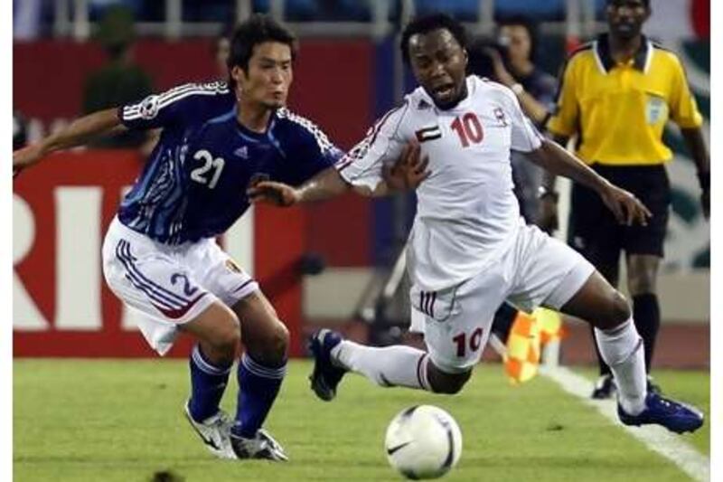 Ismail Matar is pulled down by Japan's Akira Kaji (left) during the 2007 Asian Cup.