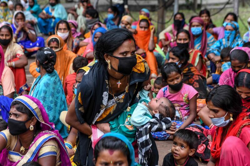 Migrant labourers and their families from Chhattisgarh sit during a protest held against the government and to demand their return to their native places outside the Deputy Commissioner's office after the government eased a nationwide lockdown, in Amritsar.  AFP