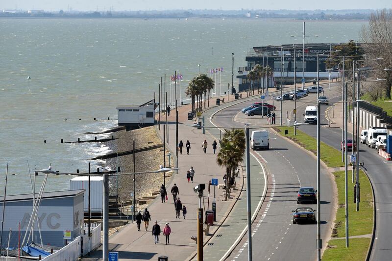 People walk along the promenade in Southend, Essex, as Prime Minister Boris Johnson has said the Government is ready to impose tougher restrictions to curb the spread of the coronavirus if people do not follow the guidance on social distancing. (Photo by Nick Ansell/PA Images via Getty Images)