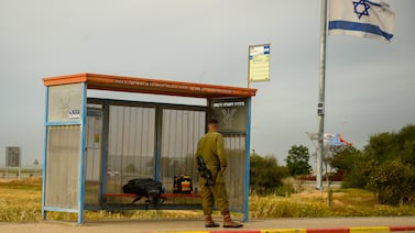 SOUTHERN ISAEL  - MARCH 21: An IDF soldier waits for bus on March 21, 2024 in southern Israel. On February 22, the IDF concluded that it was safe for residents in communities located more than 4 kilometers from the Gaza border could return. Residents responded to the government's position by countering that residents of neighboring kibbutz Sufa, less than a kilometer away, have not been advised to go back. Though some residents are eager to return, they are also concerned that until the IDF and Israeli government discuss a plan to invade Rafah, approximately 13 km away, it is not yet safe. IDF bombardments can still be heard and seen from the edges of the Kibbutz.  (Photo by Alexi J. Rosenfeld/Getty Images)
