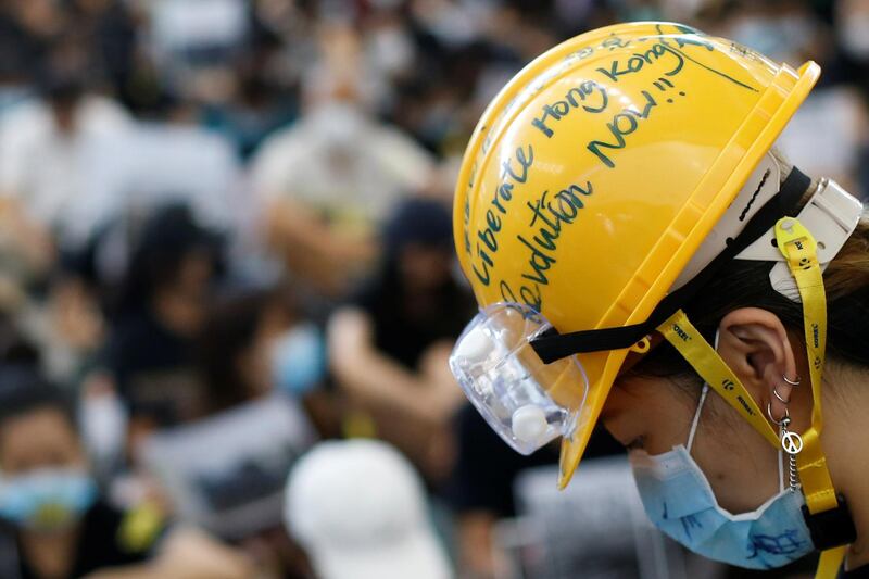 An anti-extradition bill protester wears a helmet at the arrival hall. Reuters