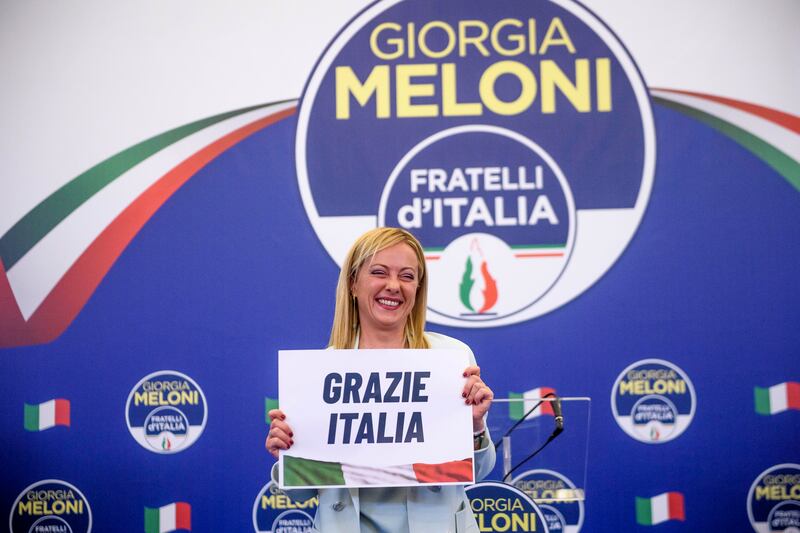 Giorgia Meloni, leader of the Fratelli d'Italia (Brothers of Italy) holds a "thank you Italy" sign during a press conference at the party electoral headquarters in Rome. Getty