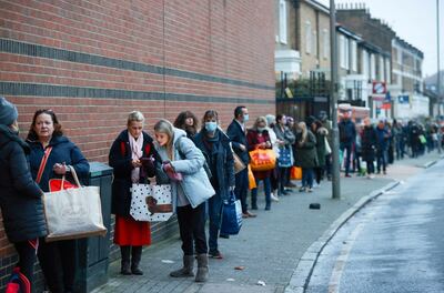 People queue outside the Waitrose and Partners supermarket, amid the coronavirus disease (COVID-19) outbreak, Balham, London, Britain December 22, 2020. REUTERS/Hannah McKay     TPX IMAGES OF THE DAY