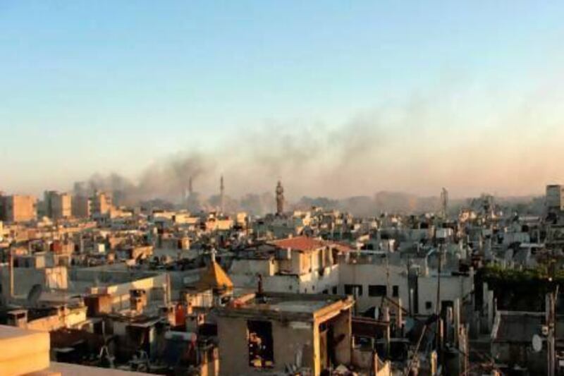 Black smoke rises from the district of Khaldiyeh in the Syrian city of Homs during fighting between rebel forces and pro-government troops.
