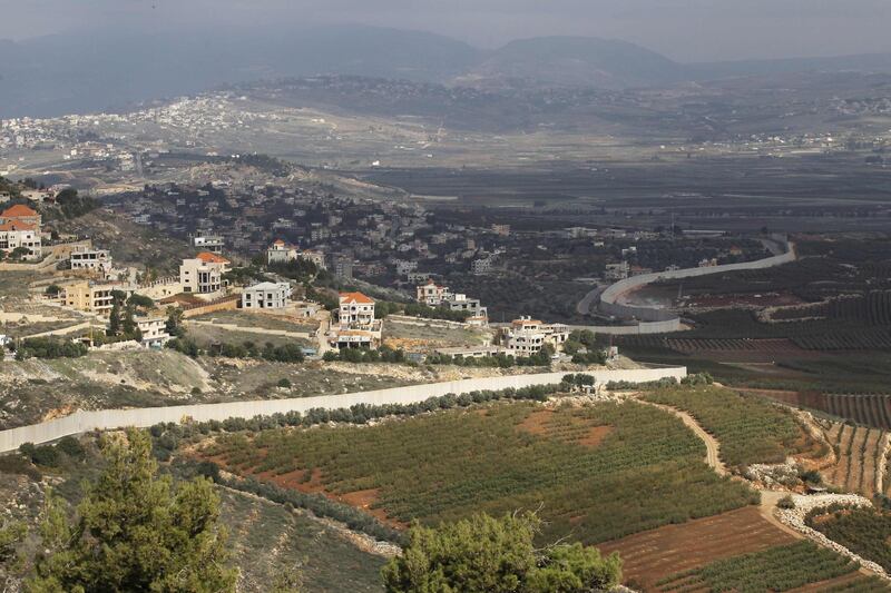 A general view taken on December 5, 2018 near the northern Israeli town of Misgav Am, shows Israeli machinery (R) operating near the border wall with Lebanon. Israeli Prime Minister Benjamin Netanyahu confirmed Israel has discovered Hezbollah tunnels infiltrating its territory yesterday. During the press conference Israel's army chief of staff also revealed footage he said showed members of the Lebanese Shiite movement walking through a tunnel discovered on the Israel-Lebanon border. / AFP / JALAA MAREY
