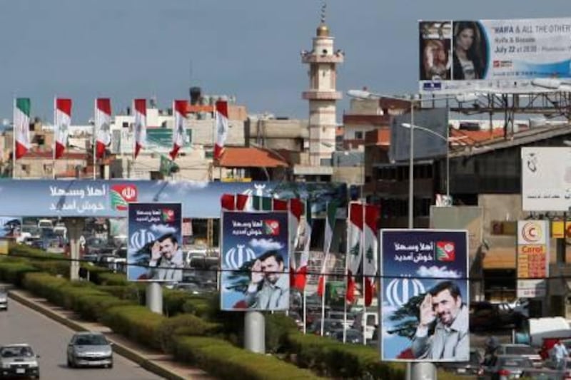 Billboards with images of Iranian President Mahmoud Ahmadinejad decorate a street in Beirut's suburbs October 11, 2010, as part of preparation for his visit to Lebanon. Iranian President Mahmoud Ahmadinejad is expected to visit Lebanon from October 13-14 and tour villages in southern Lebanon. REUTERS/ Jamal Saidi   (LEBANON - Tags: POLITICS CITYSCAPE) *** Local Caption ***  LBN07_LEBANON-_1011_11.JPG