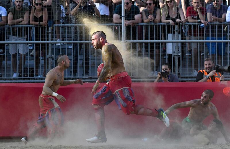 Players take part in the game of the Calcio Storico Fiorentino, a traditional football match played in costume, in Florence, Italy. EPA