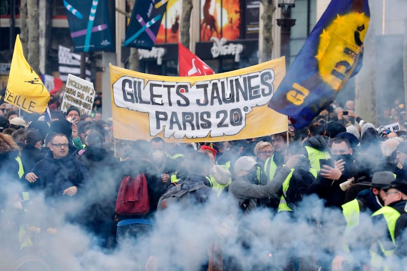 Protesters wave French regional flags on the Champs-Elysees in Paris. AFP