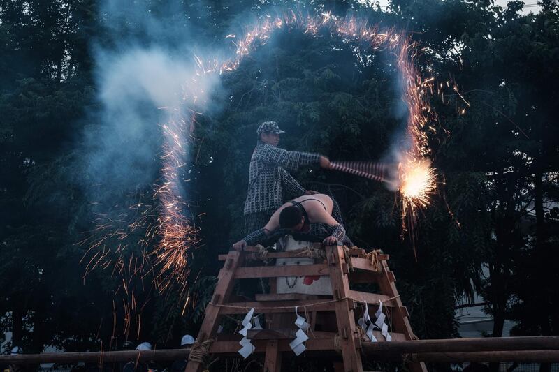 A man drawing the word for water three times with fireworks. AFP