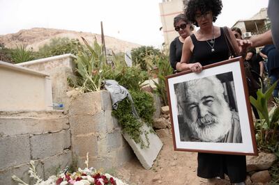 Mourners raise a portrait of Khaled Kahlifa.