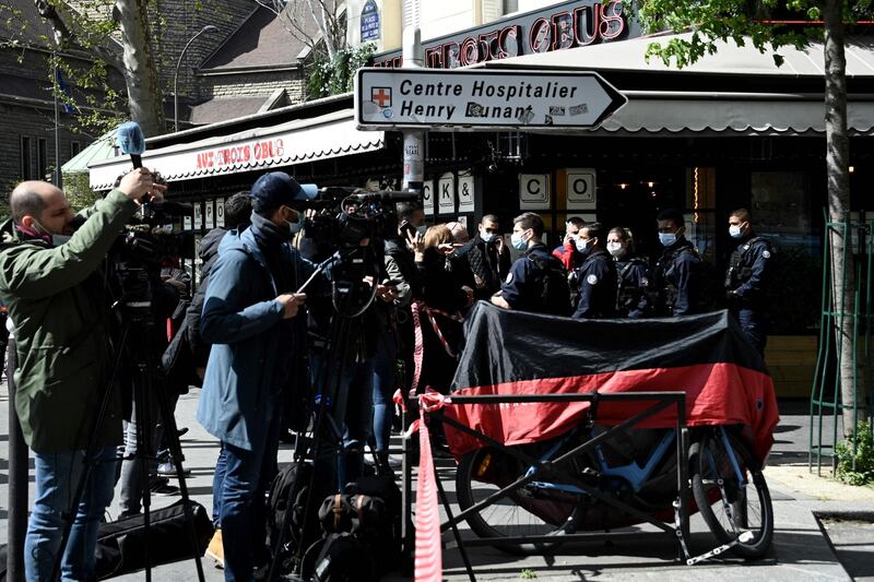 Journalists gather as French police cordon off the area. AFP