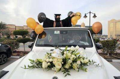 Ajman, United Arab Emirates - Reporter: Anam Rizvi. News. Andalus Abdulwahhab celebrates out the sunroof of her car before her drive through graduation from Ajman University because of Covid-19. Wednesday, February 10th, 2021. Ajman. Chris Whiteoak / The National
