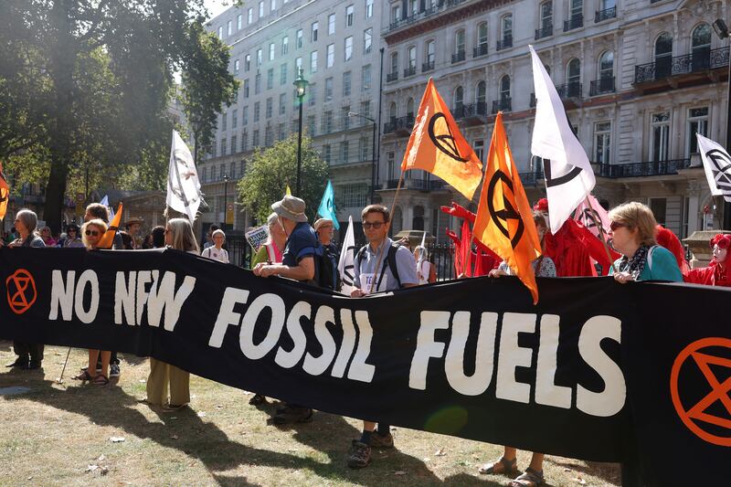 Demonstrators in London hold a banner during a global protest to end fossil fuels on September 16. Reuters