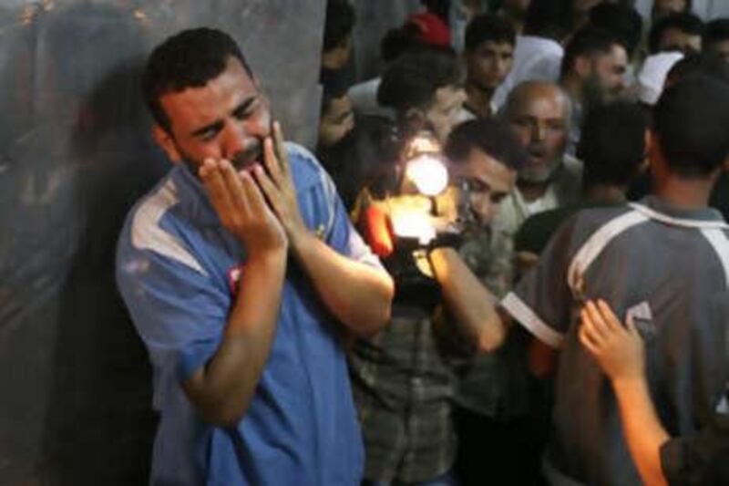 A Palestinan man cries in mourning over a victim killed in an explosion, in the mortuary at Shifa hospital in Gaza City yesterday.