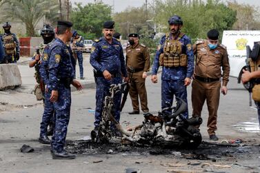 Members of Iraqi security forces inspect the scene of an explosion in Baghdad on March 23, 2021. Reuters