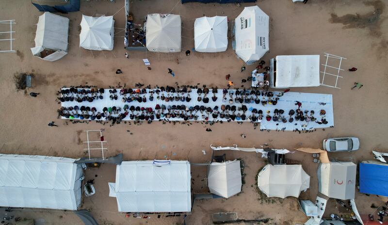 A drone view shows displaced Palestinians in Rafah gathering for iftar. Reuters