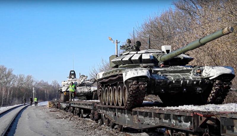 Russian tanks are loaded on to railway platforms to move back to their permanent base after drills. Russian Defence Ministry Press Service via AP
