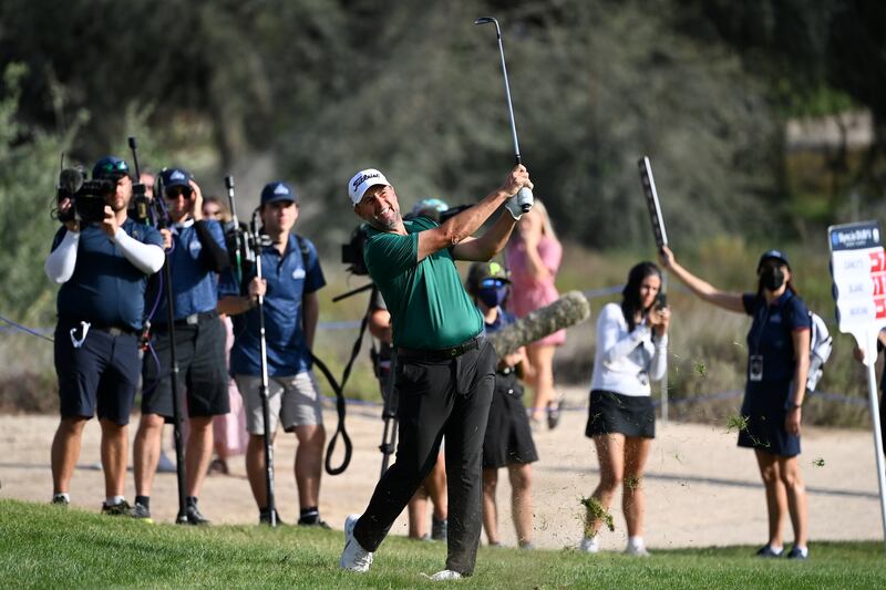 Richard Bland hits his second shot on the 16th hole. Getty