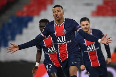 TOPSHOT - Paris Saint-Germain's French forward Kylian Mbappe celebrates after scoring a penalty kick during the UEFA Champions League round of 16 second leg football match between Paris Saint-Germain (PSG) and FC Barcelona at the Parc des Princes stadium in Paris, on March 10, 2021. / AFP / FRANCK FIFE