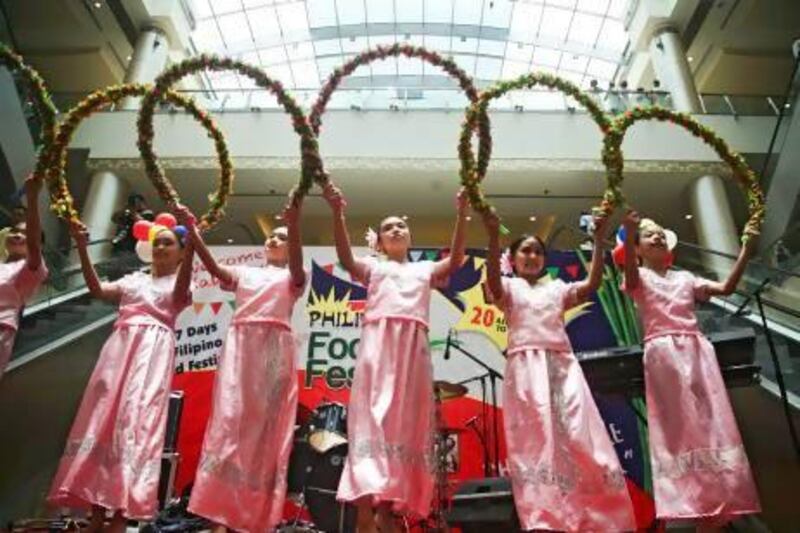Six young Filipinas dance at yesterday's opening of the week-long Philippine Food Festival at Khalidiyah Mall. Lee Hoagland / The National