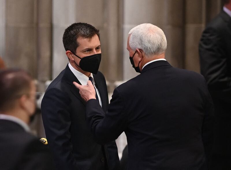 Former US vice president Mike Pence speaks with Transport Secretary Pete Buttigieg at the Washington National Cathedral. AFP