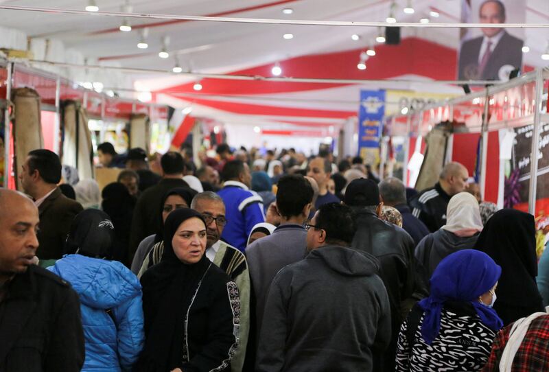 Egyptians crowd at a market selling food at discounted prices in Cairo. Controlling overpopulation has become a national priority. Reuters