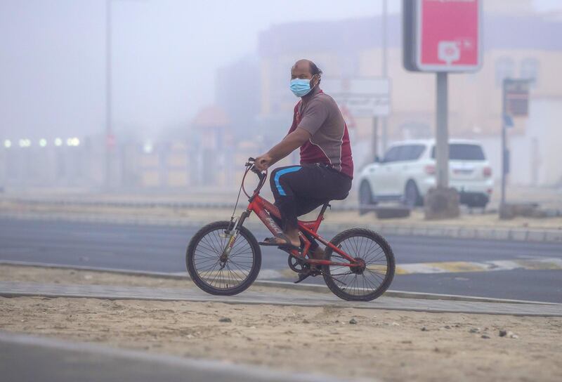 Abu Dhabi, United Arab Emirates, February 13, 2021. Foggy morning at Khalifa City, Abu Dhabi.  A man on his bike amidst the fog.
Victor Besa/The National
Section: Weather