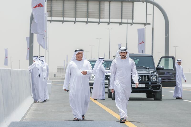 Sheikh Hamdan walks along the side of the Dh2 billion Dubai-Al Ain motorway. 