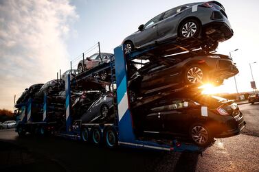 A lorry with a car carrier trailer leaves the Honda car plant in Swindon, Britain. The company hopes to restart operations at its factory once supply delays ease. Reuters