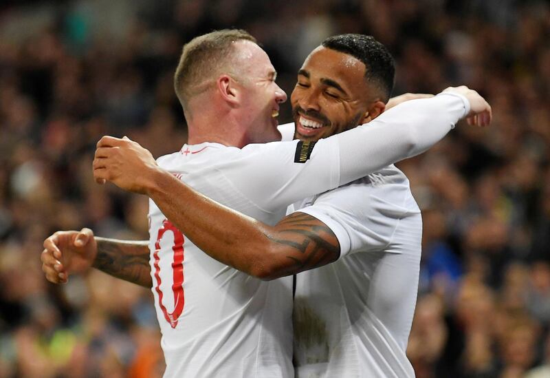 England's Callum Wilson celebrates scoring their third goal with Wayne Rooney. REUTERS