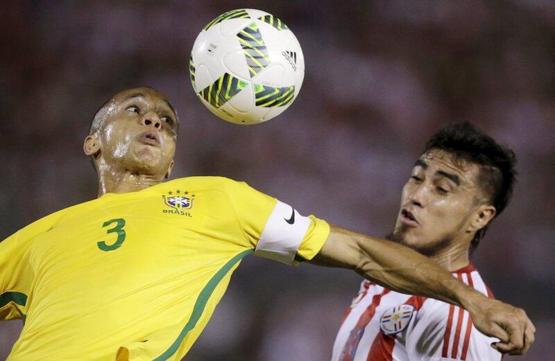 Miranda (L) of Brazil and Dario Lezcano of Paraguay. REUTERS/Jorge Adorno